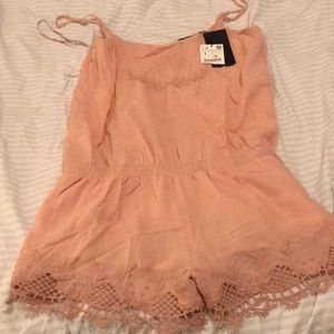 A polyester embroidered pink romper.